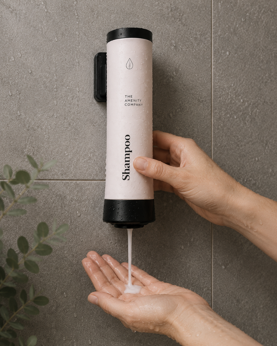 Hand pressing a wall-mounted dispenser in a tiled shower