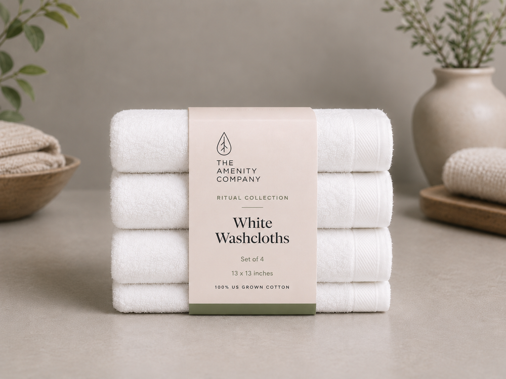 Stack of four white washcloths with a Ritual Collection belly band